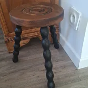 Brown and black wooden tripod stool