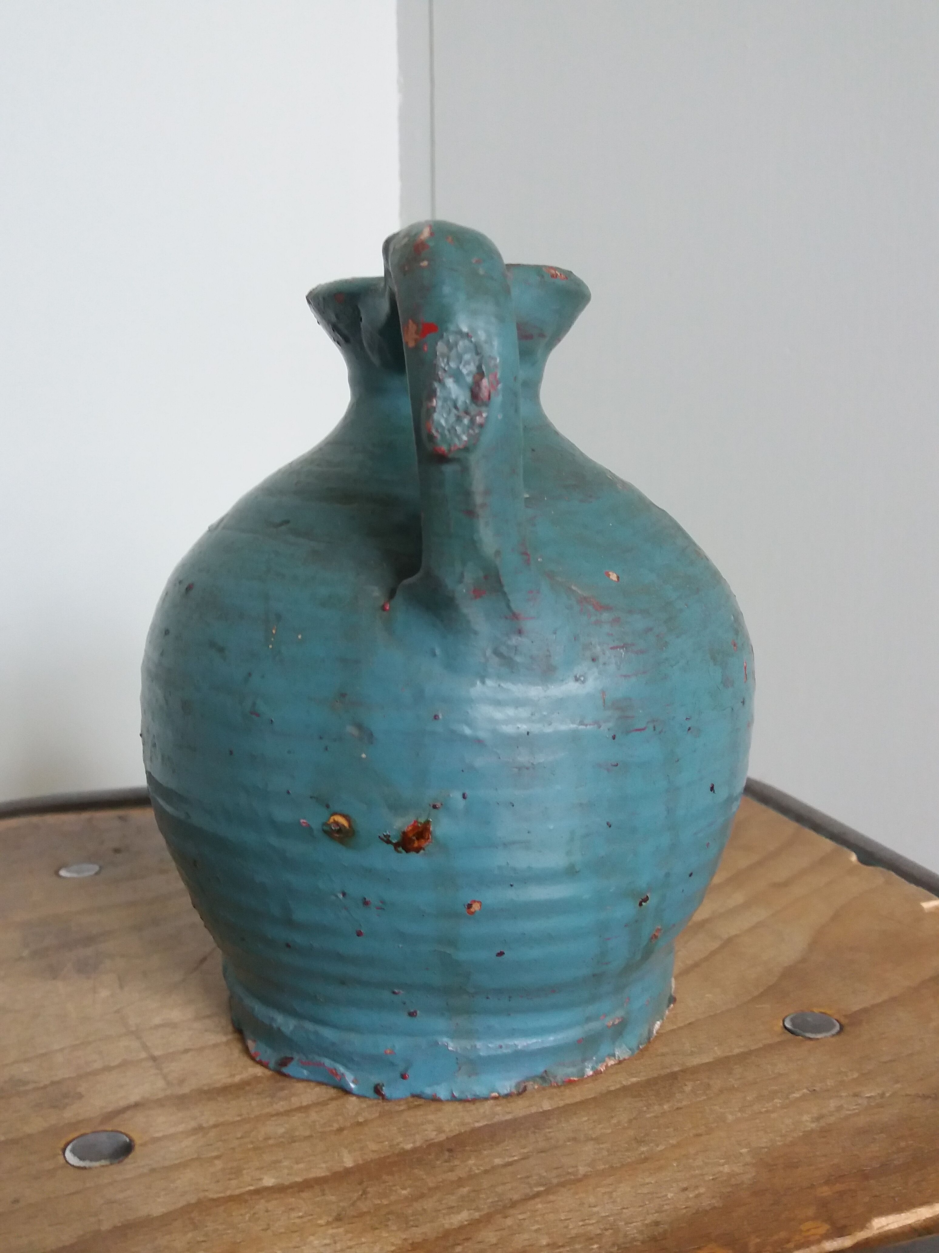 Sandstone pitcher painted in turquoise, very old pottery