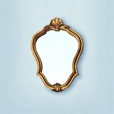 Old small wall mirror in golden resin