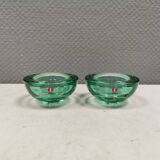 A set of iitalla candle holders in green transparent glass.