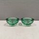 Un ensemble de porte-bougies iittala en verre transparent vert.