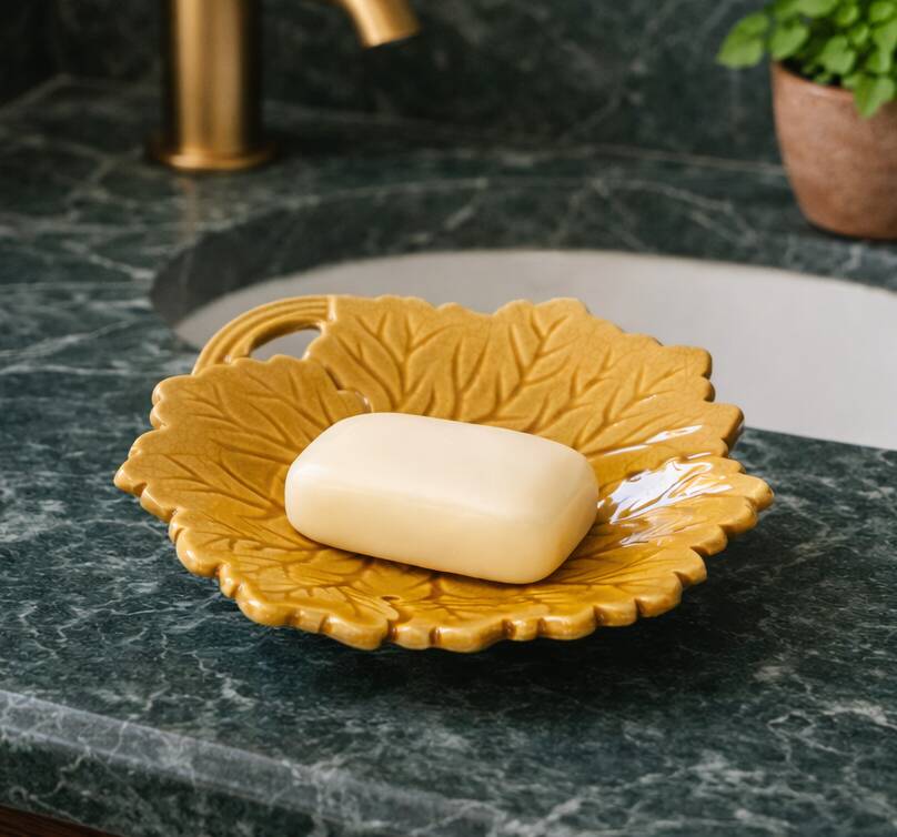 Vintage soap dish in ochre faience, leaf shape.
