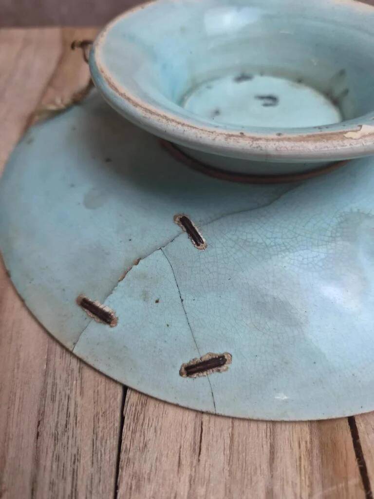 Old small compote dish in turquoise majolica with raised floral decoration.