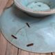 Old small compote dish in turquoise majolica with raised floral decoration.