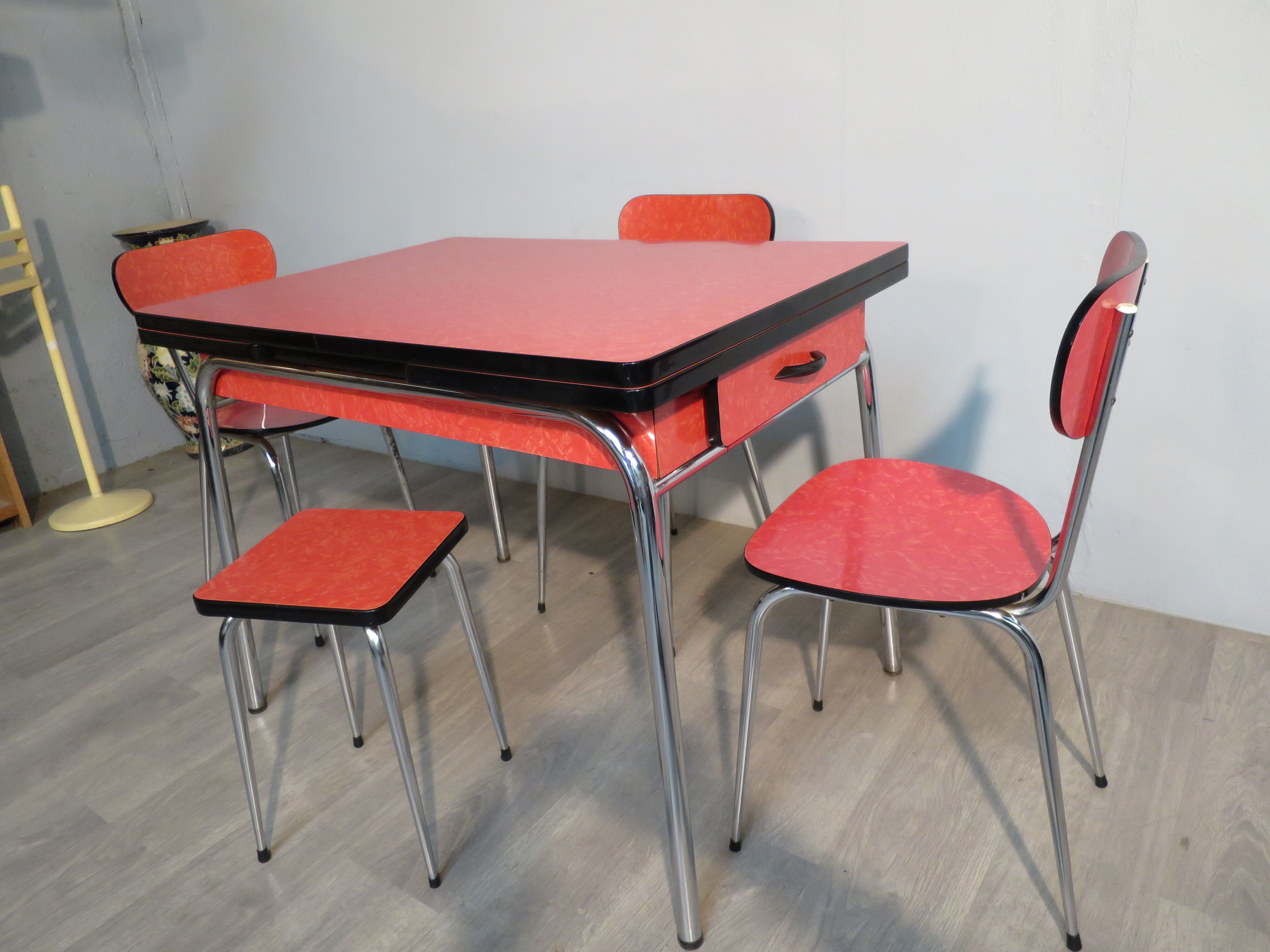 Table, 3 chairs and red formica stool