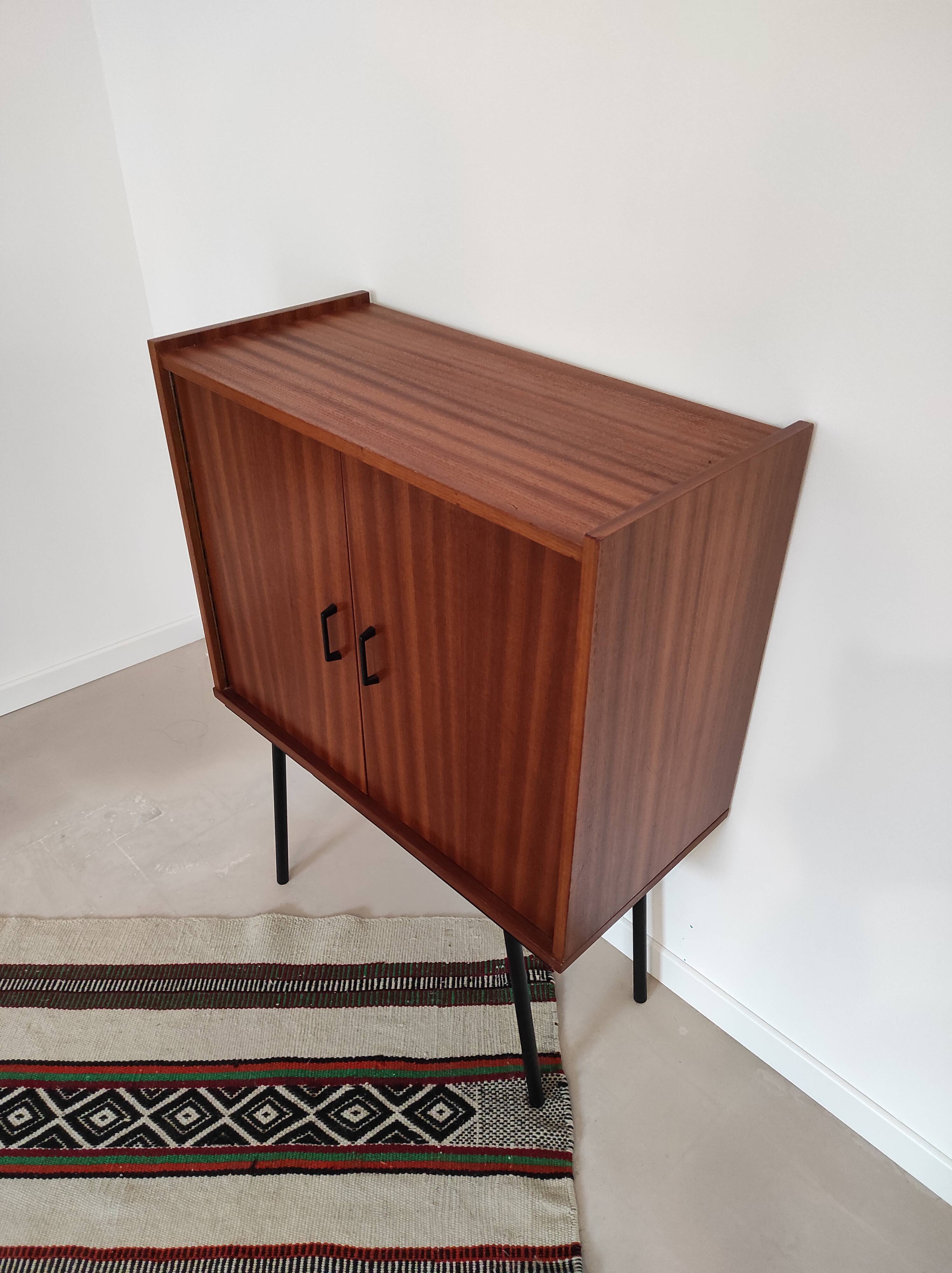 Piece of furniture on high feet metal compass