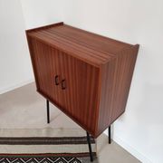 Piece of furniture on high feet metal compass