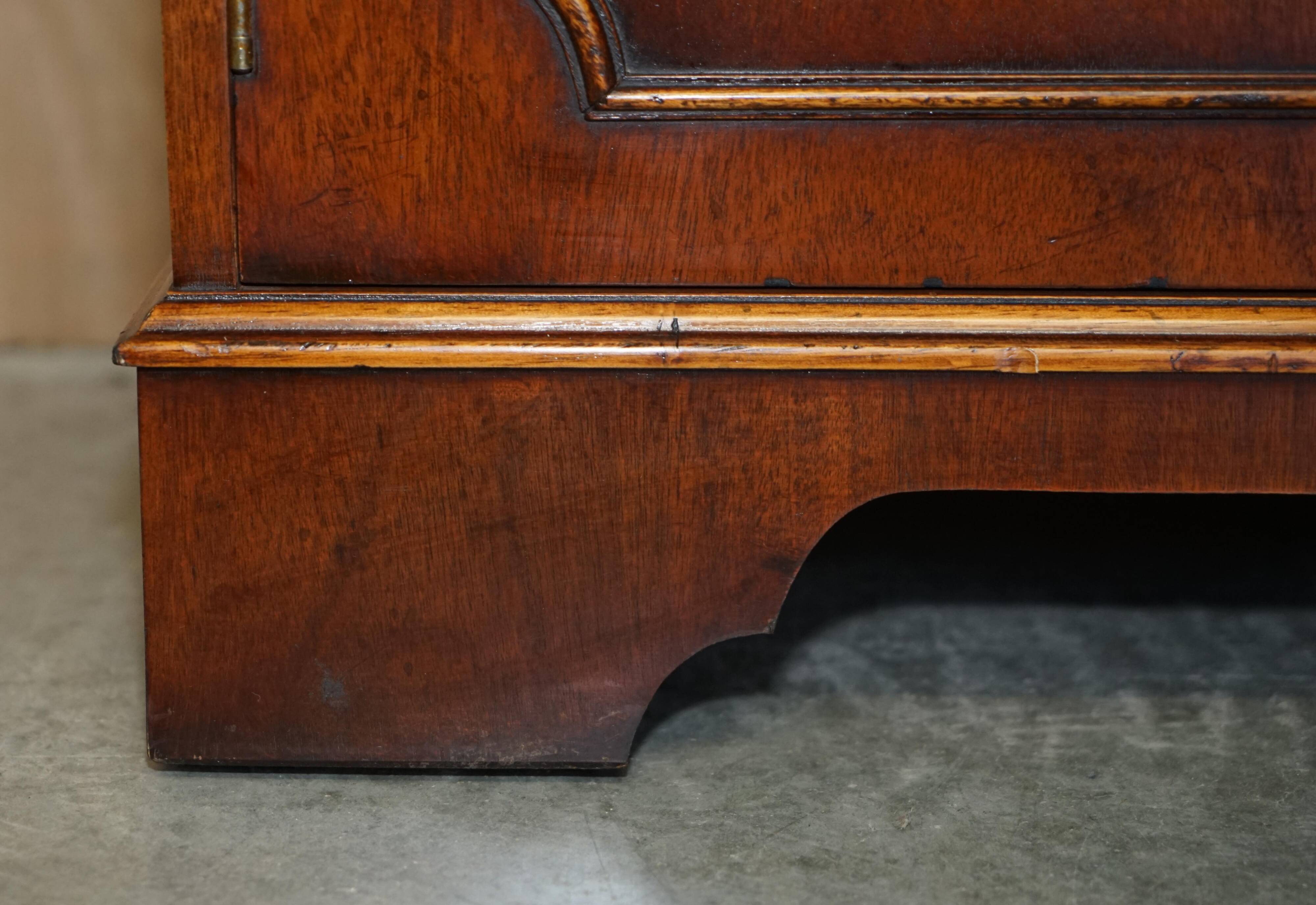 Vintage mahogany buffet with three drawers and shelves.