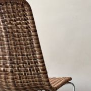 Chair design in rattan, woven wicker and chrome wire metal.
