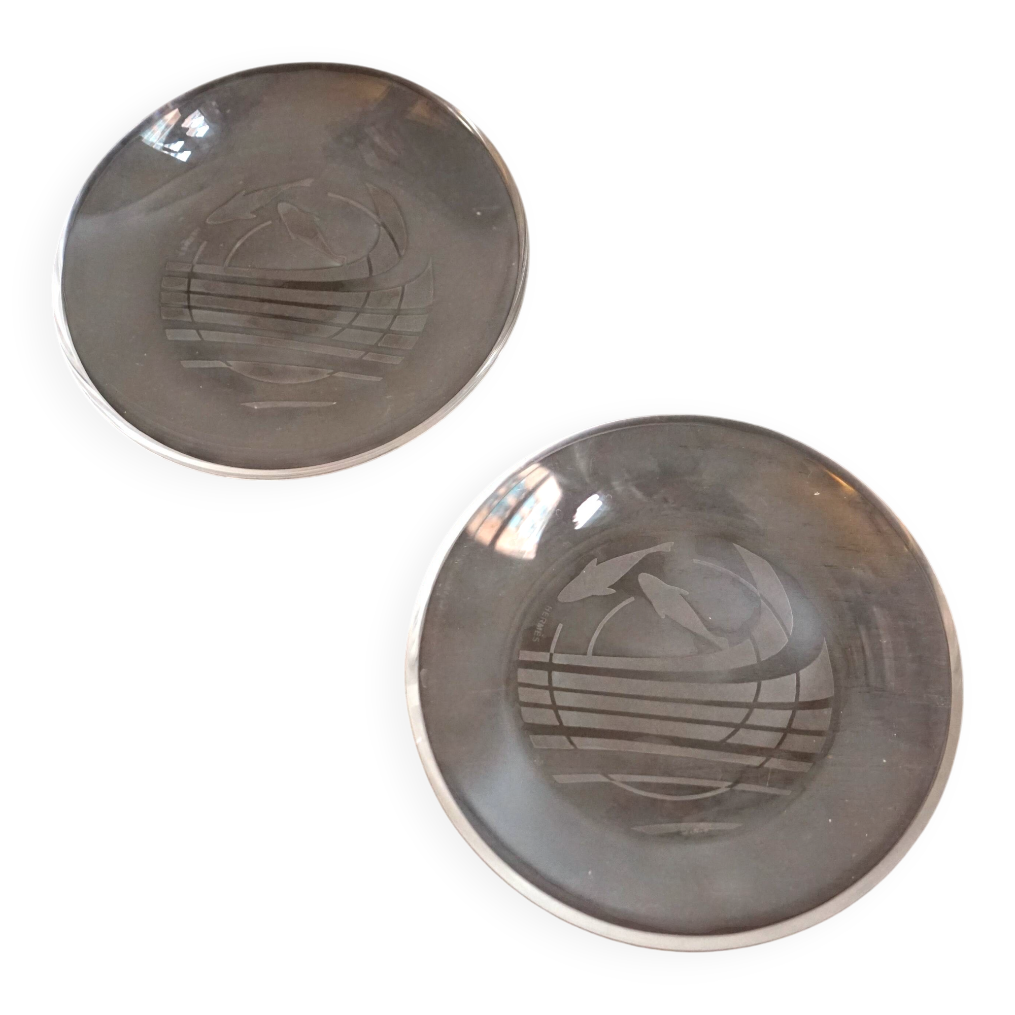 Hermès pair of glass plates with a dolphin pattern.
