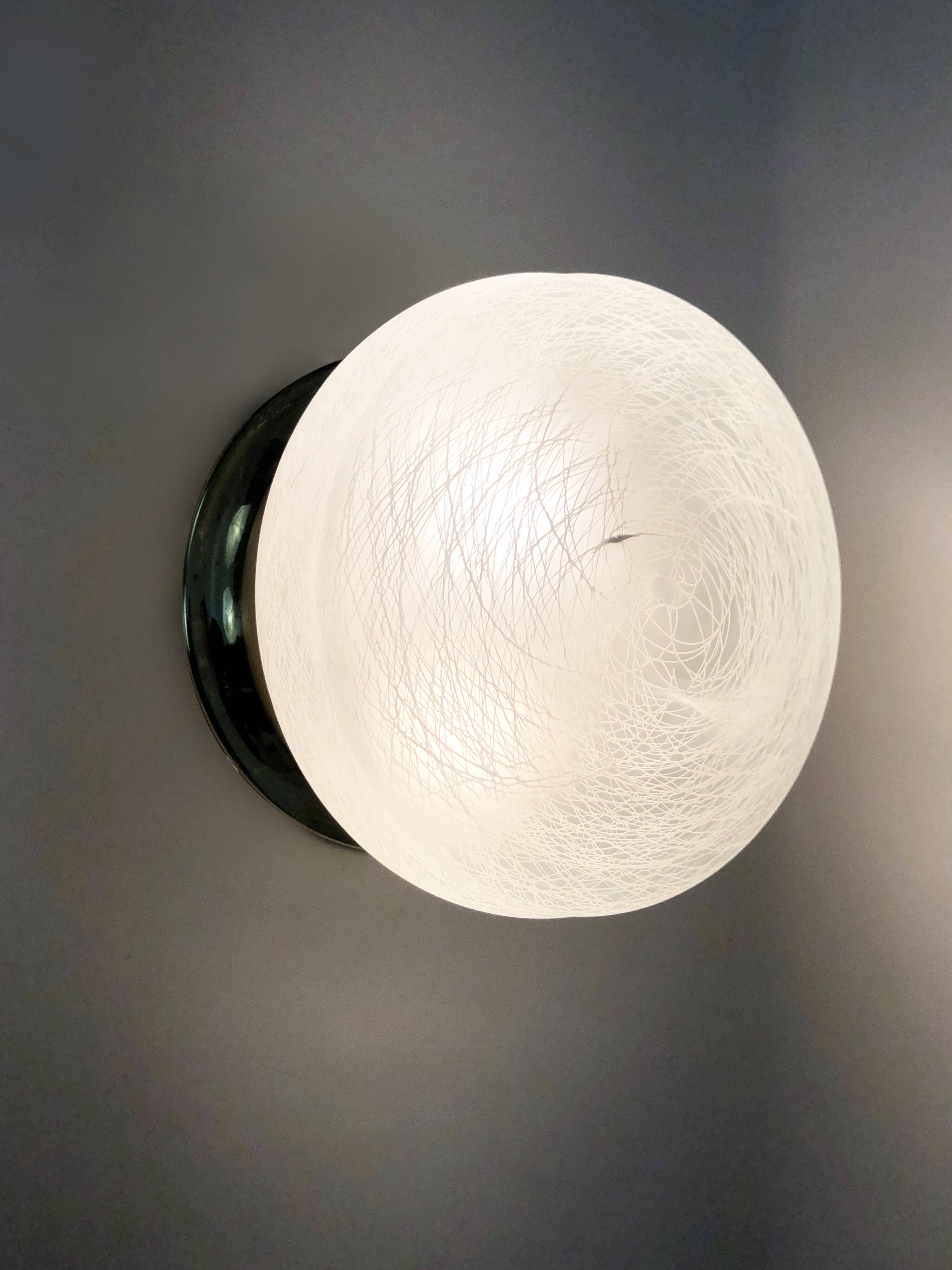 Pair of wall or ceiling lights with white-edged globe. 80 years