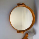 Tilting orange plastic mirror with its matching wall light