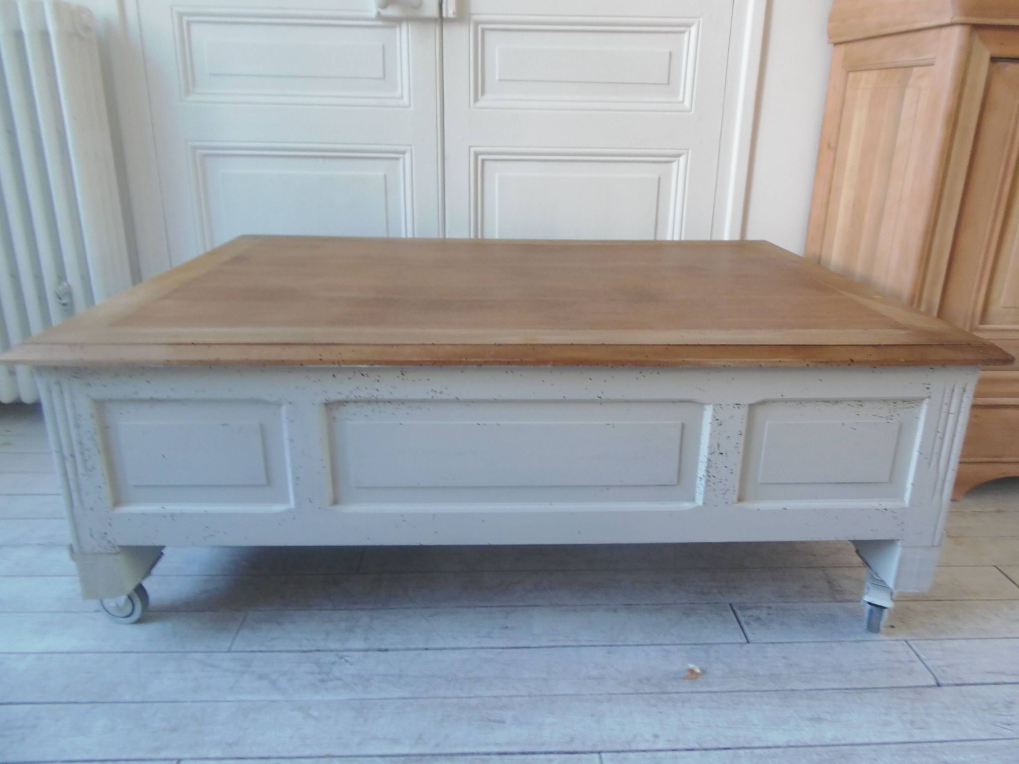 Coffee table on casters, made from an old desk, pearl gray base and belt.