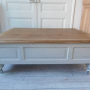Coffee table on casters, made from an old desk, pearl gray base and belt.