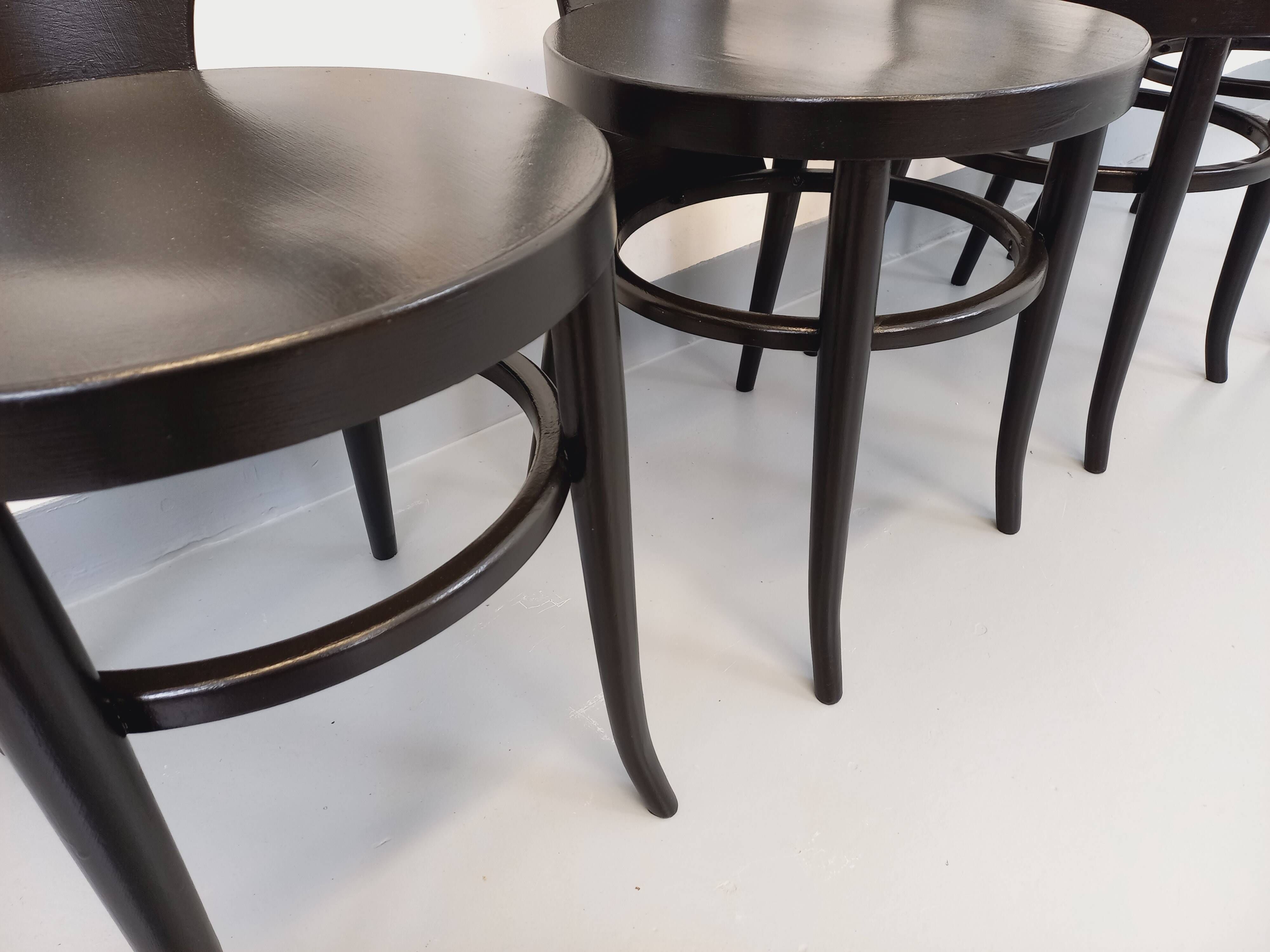 Set of 4 vintage Mouette chairs by Baumann in black wood from the 1960s.