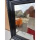 Black lacquered wood mirror "originally punctured"