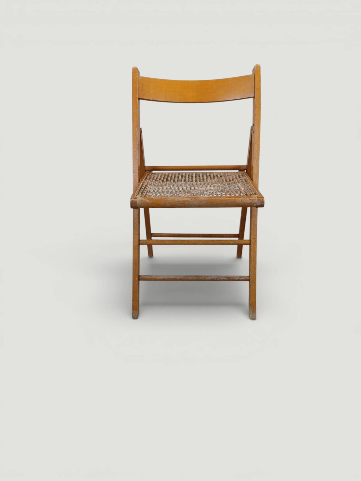 Vintage folding chair with caning.