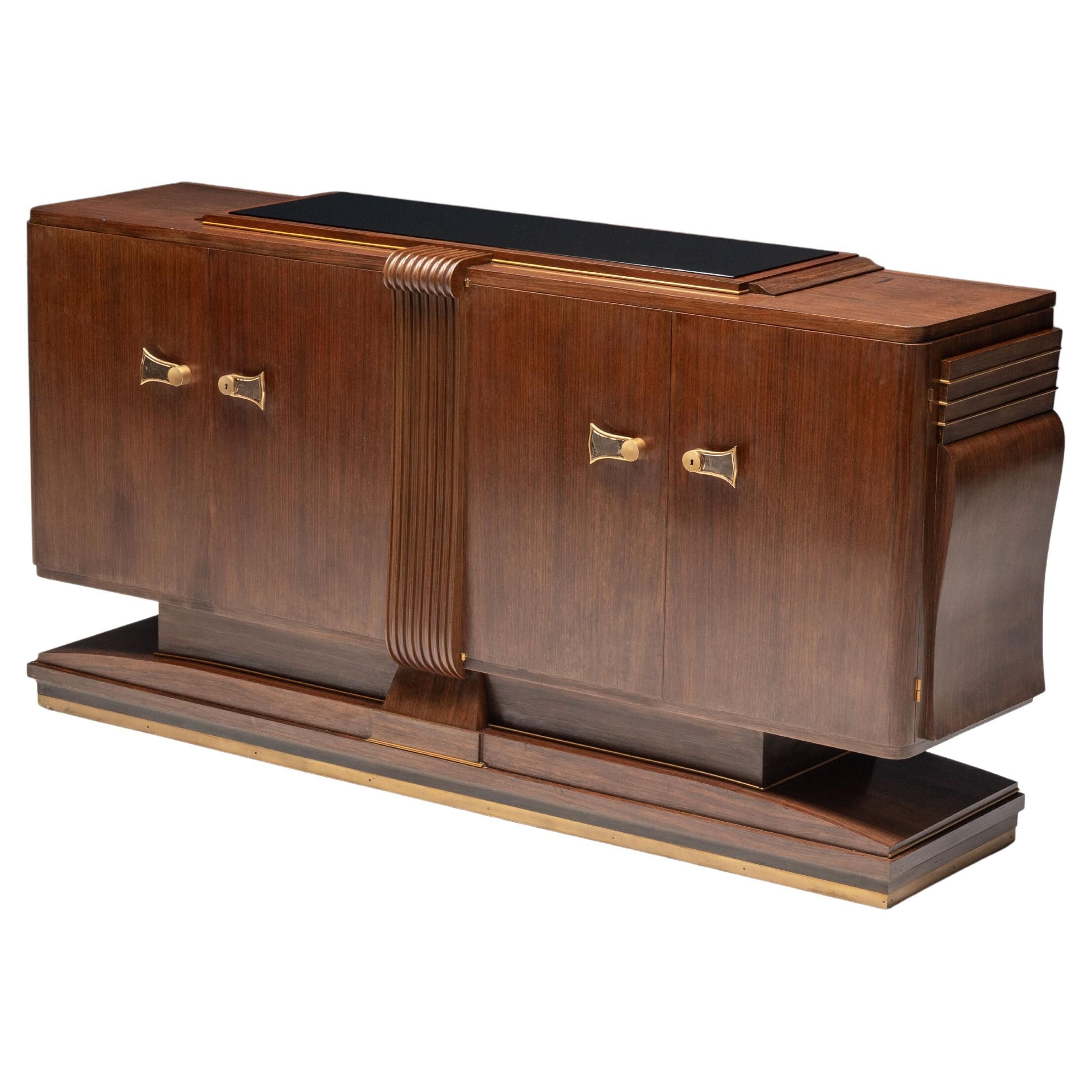 Art Deco walnut sideboard with brass details and sculptural base, France, 1930s