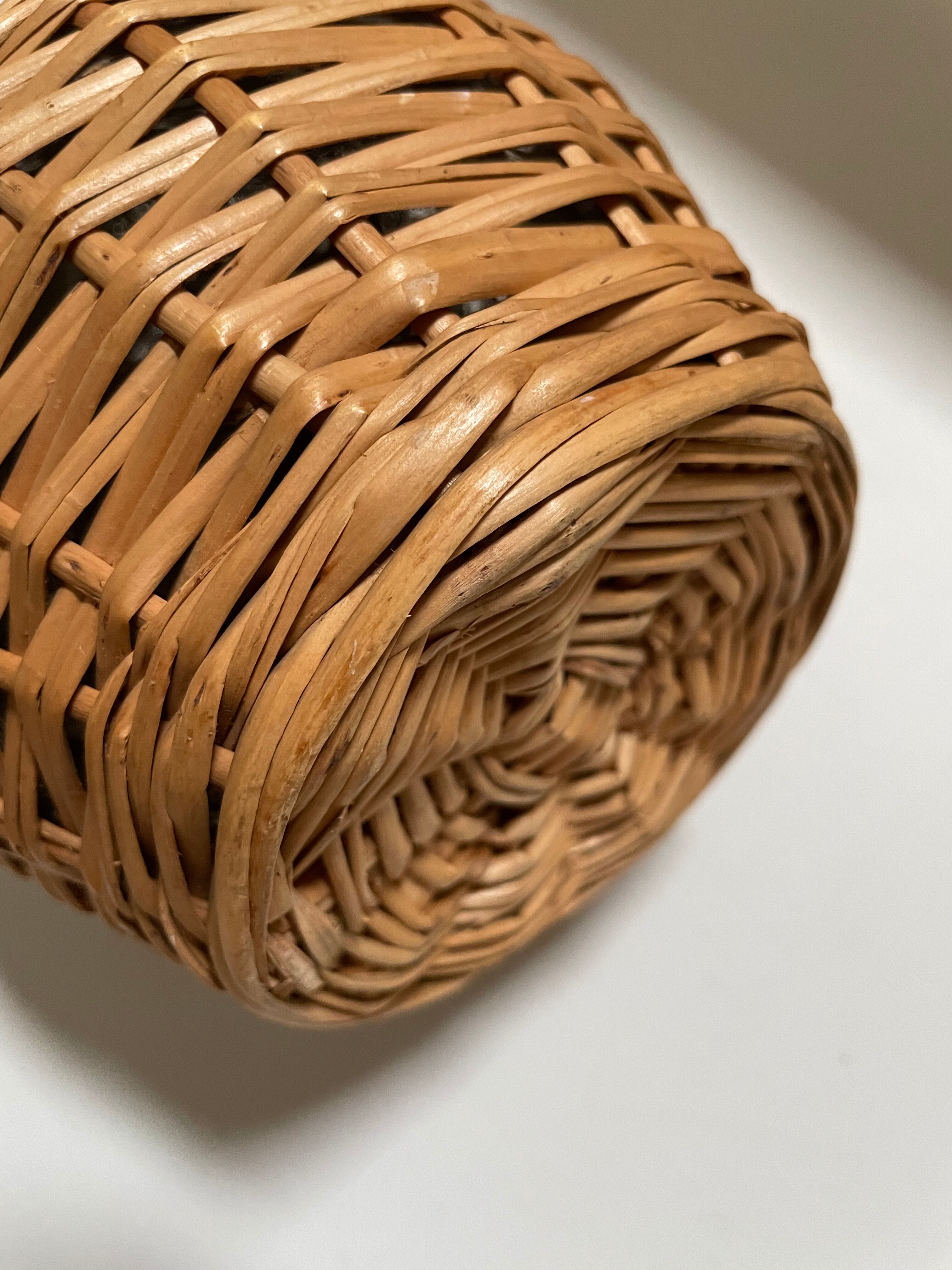 Glass bottle surrounded by wicker