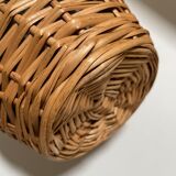 Glass bottle surrounded by wicker