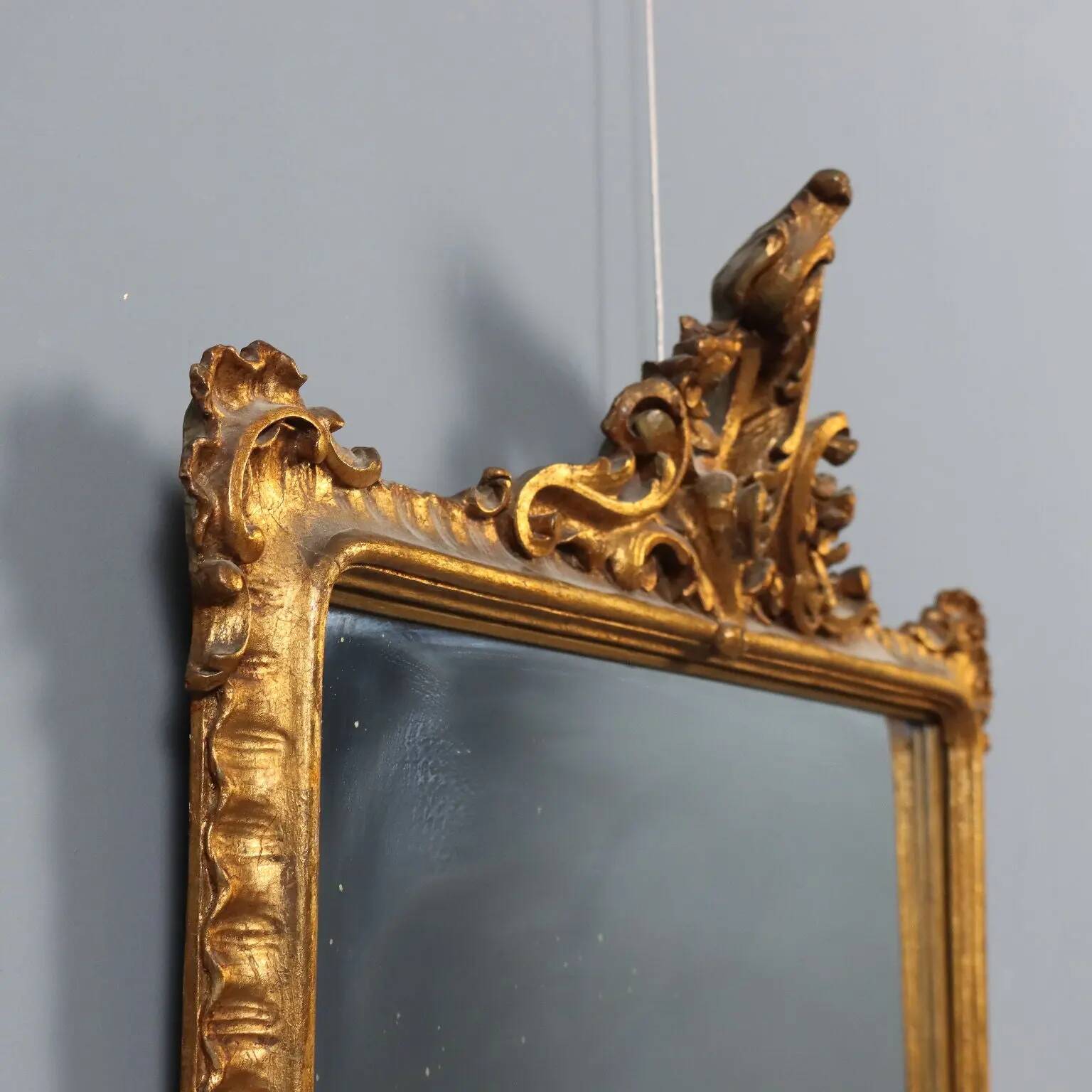 Antique Rococo-style mirror in carved gilded wood, 20th century.