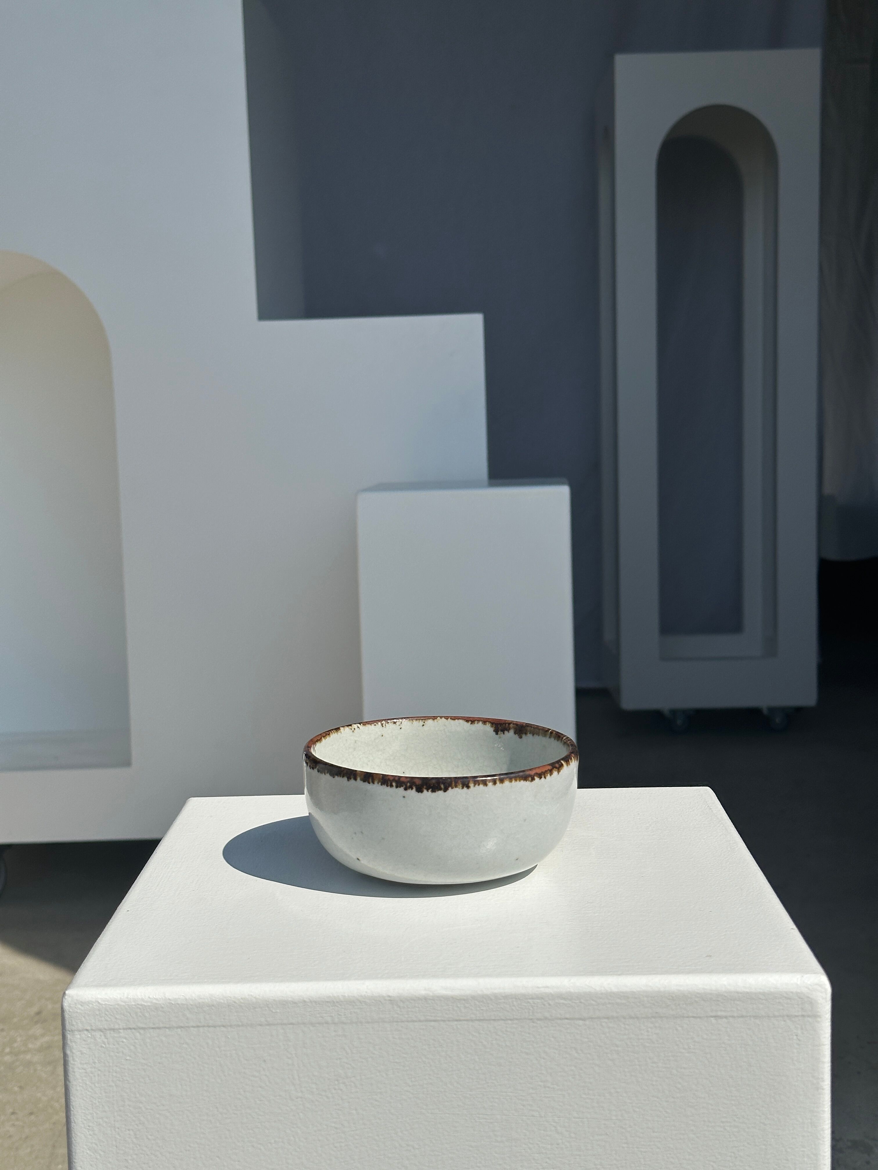 Small white glazed ceramic bowl black edges