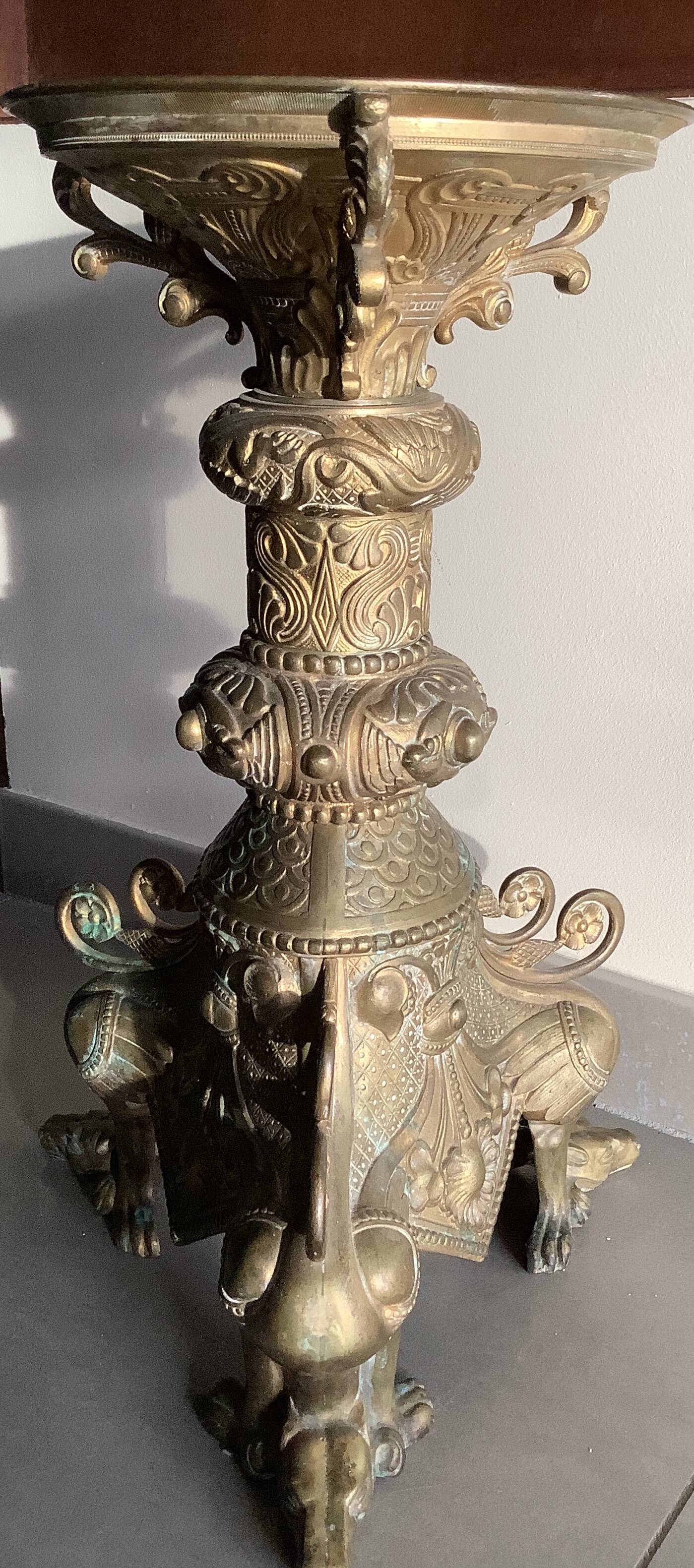 Large bronze candlestick with tripod and winged dog decoration, 19th century.