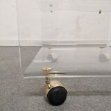 End of sofa with glass and plexiglass wheels from the 70s