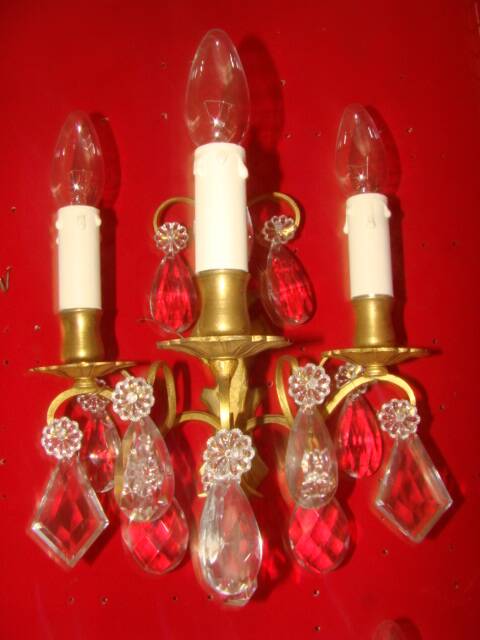 Pair of bronze and crystal wall lights with three candle holders from the early 20th century.