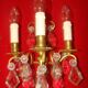 Pair of bronze and crystal wall lights with three candle holders from the early 20th century.