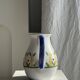 Large white terracotta carafe with a stylized green and yellow frieze pattern