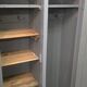 Curved wardrobe workshop locker made of wood repainted in grey.