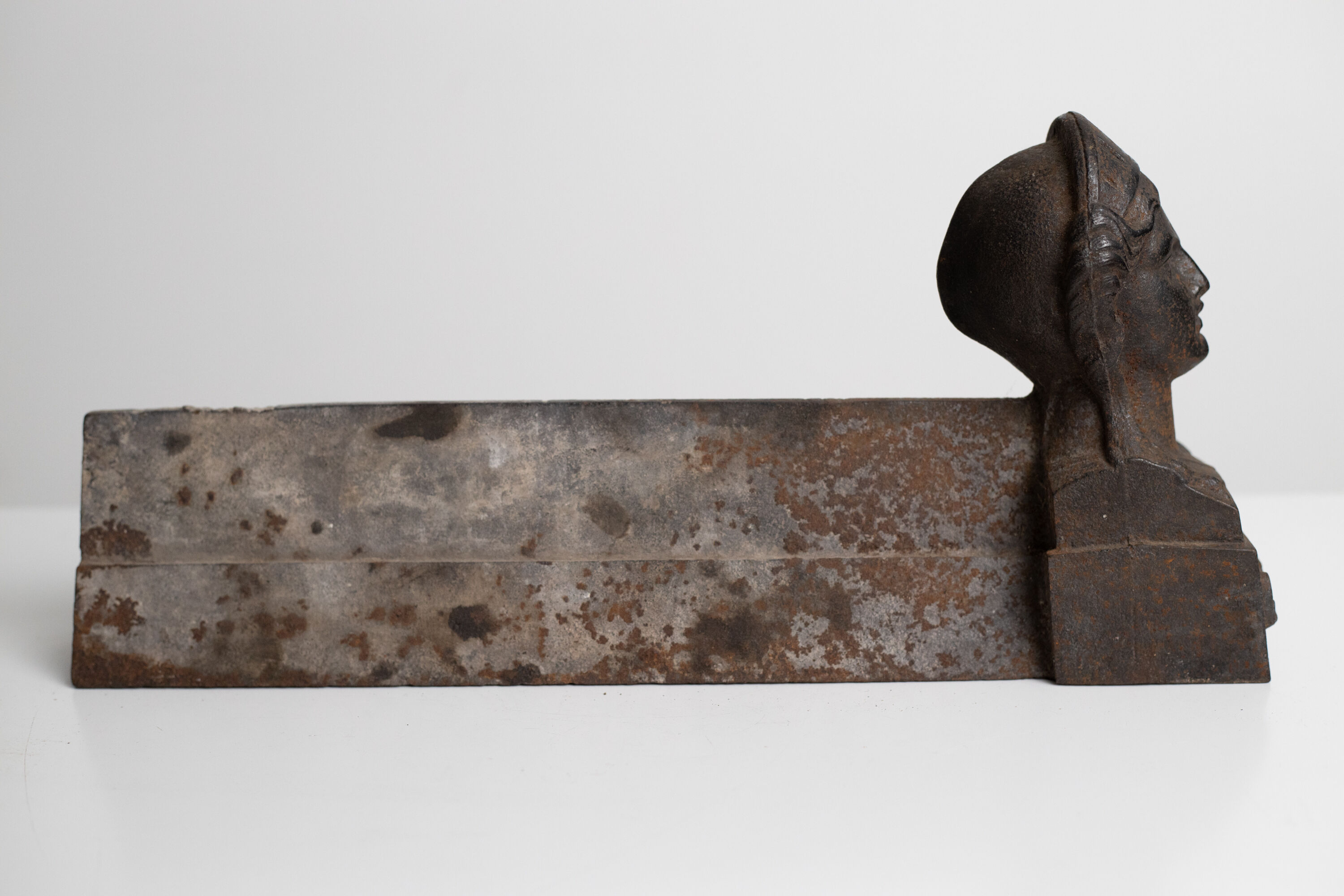 Pair of ancient cast iron chenets adorned with bust of Marianne