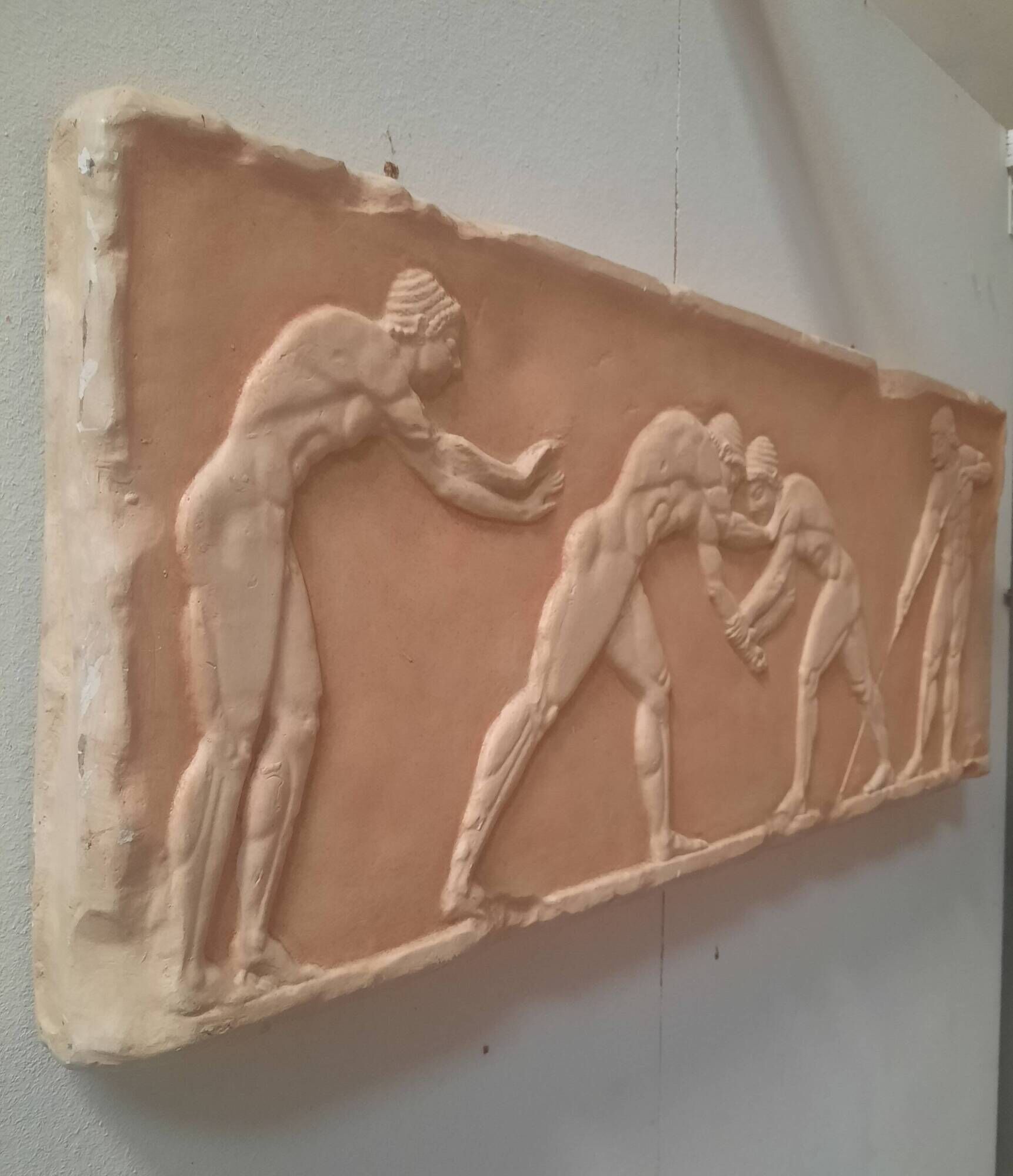 Bas-relief in the antique style featuring athletes.