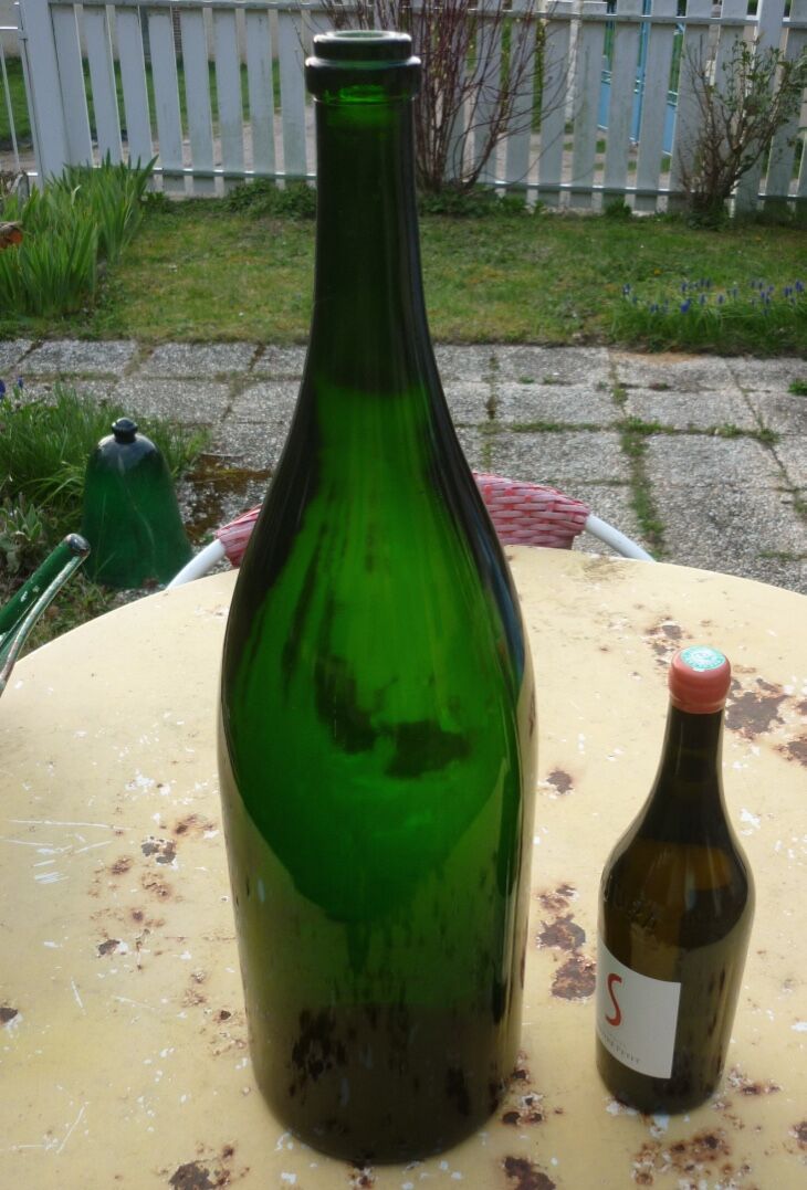 Green blown glass bottle of 58 cm.