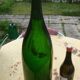 Green blown glass bottle of 58 cm.