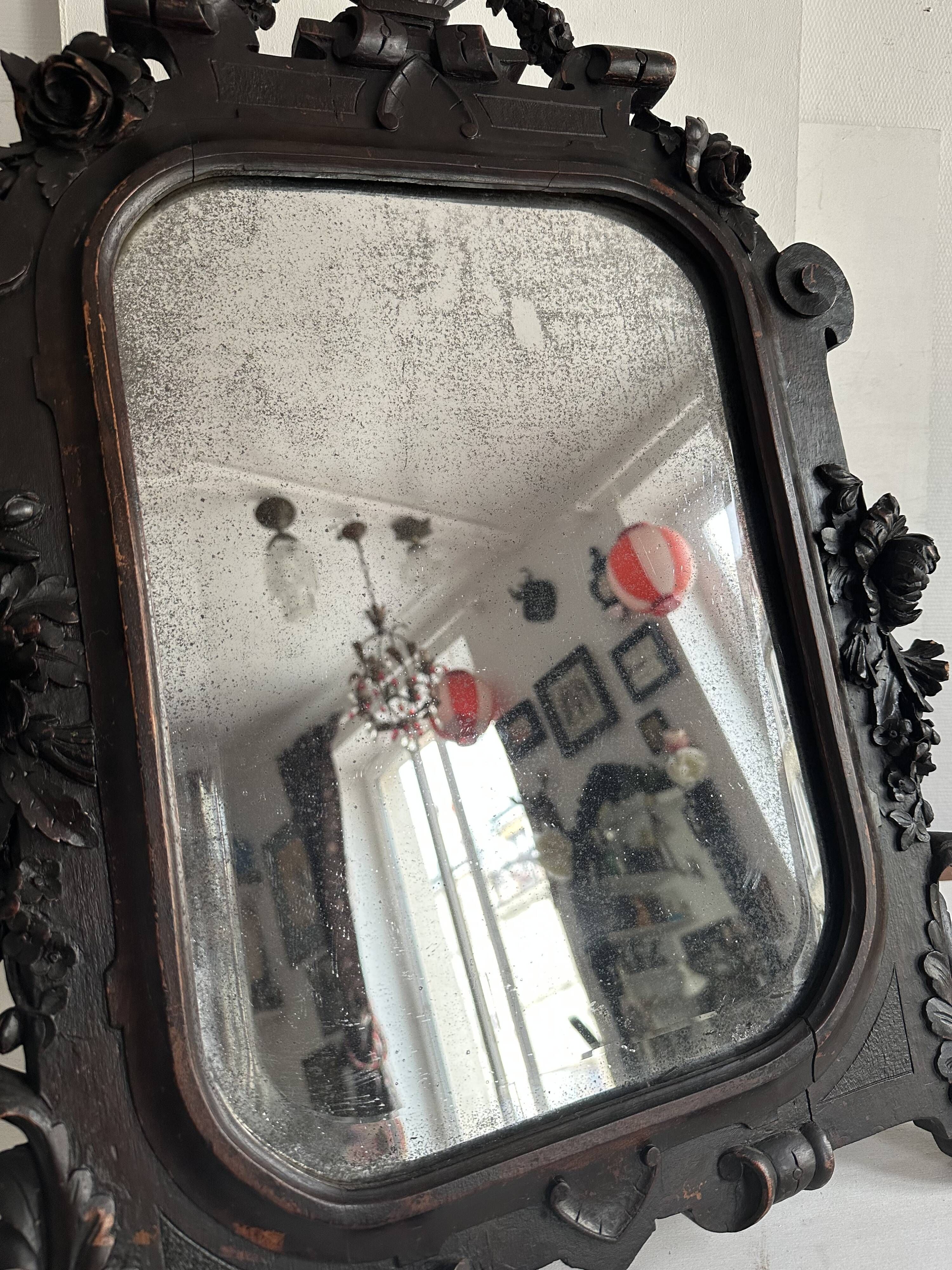 Napoleon III mirror in carved blackened wood, 19th century