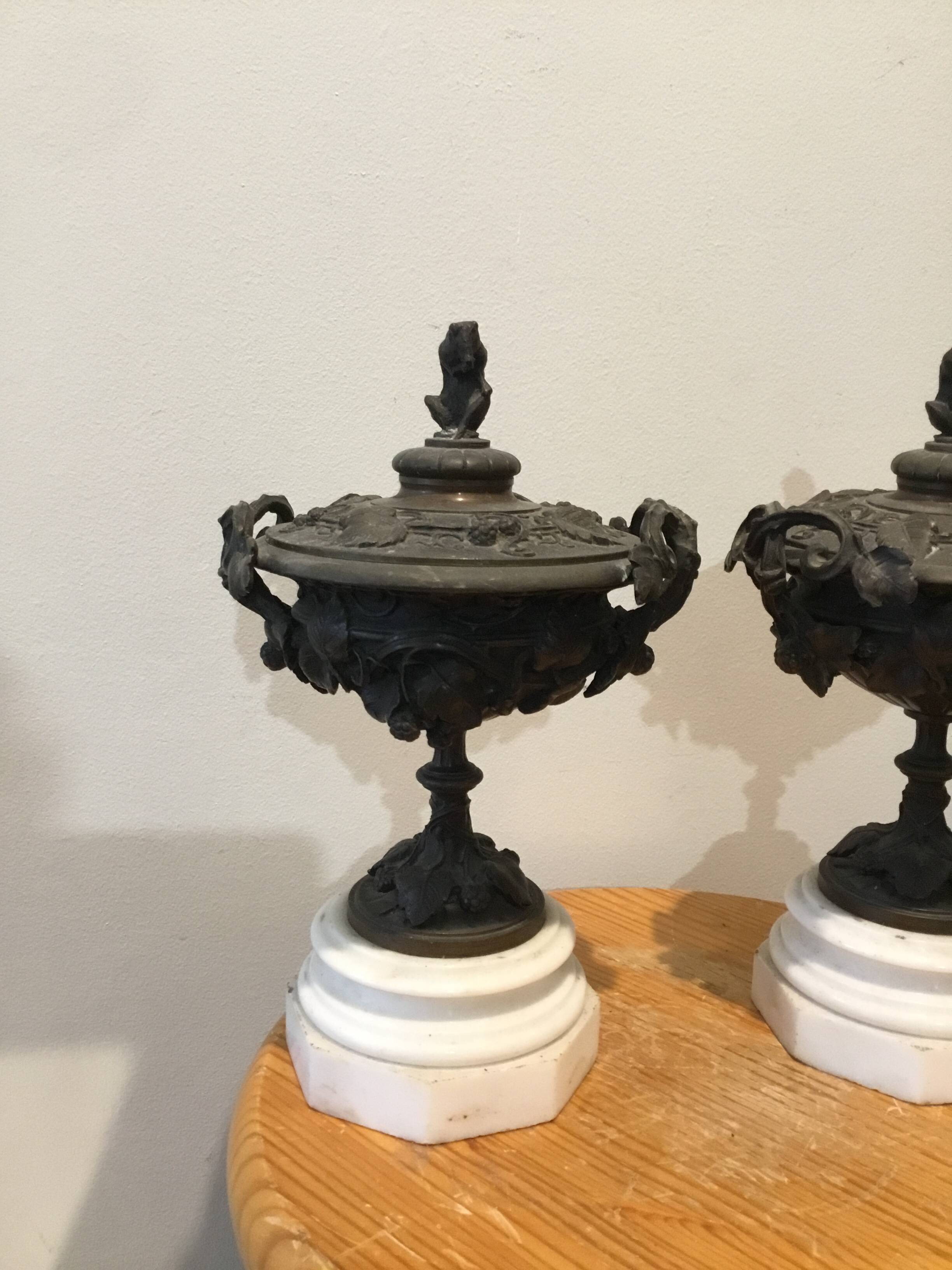Bronze fireplace garnitures with marble base depicting leaves.