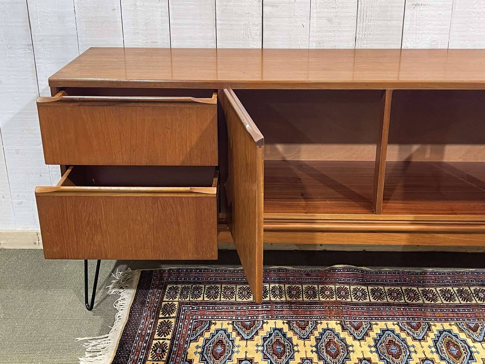 1970s English enfilade in teak with splayed legs.
