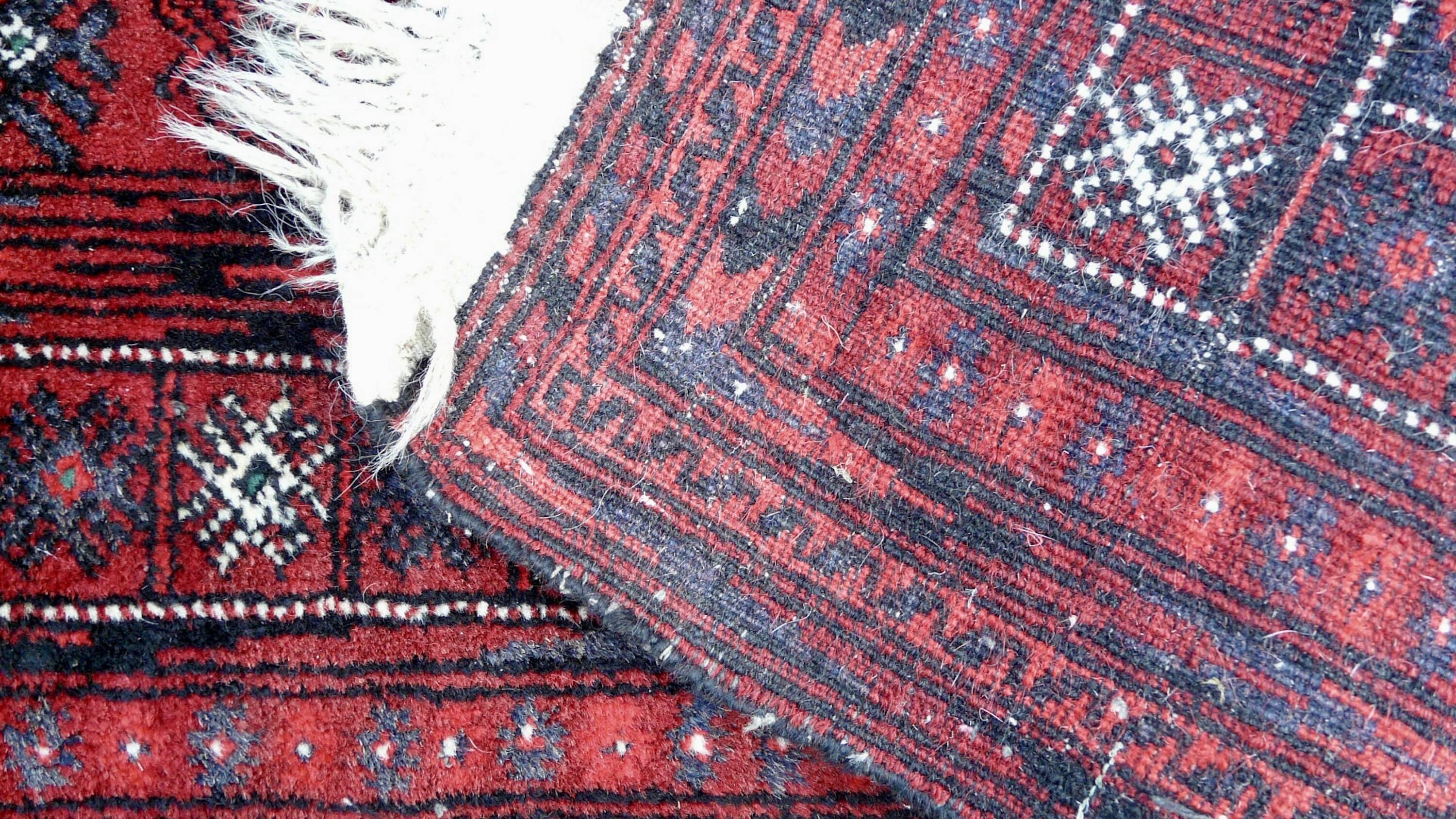 Antique Persian Bukhara hand-knotted rug