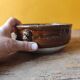 Old small glazed ceramic dish with lion head decoration - brown enamel kitchen bowl