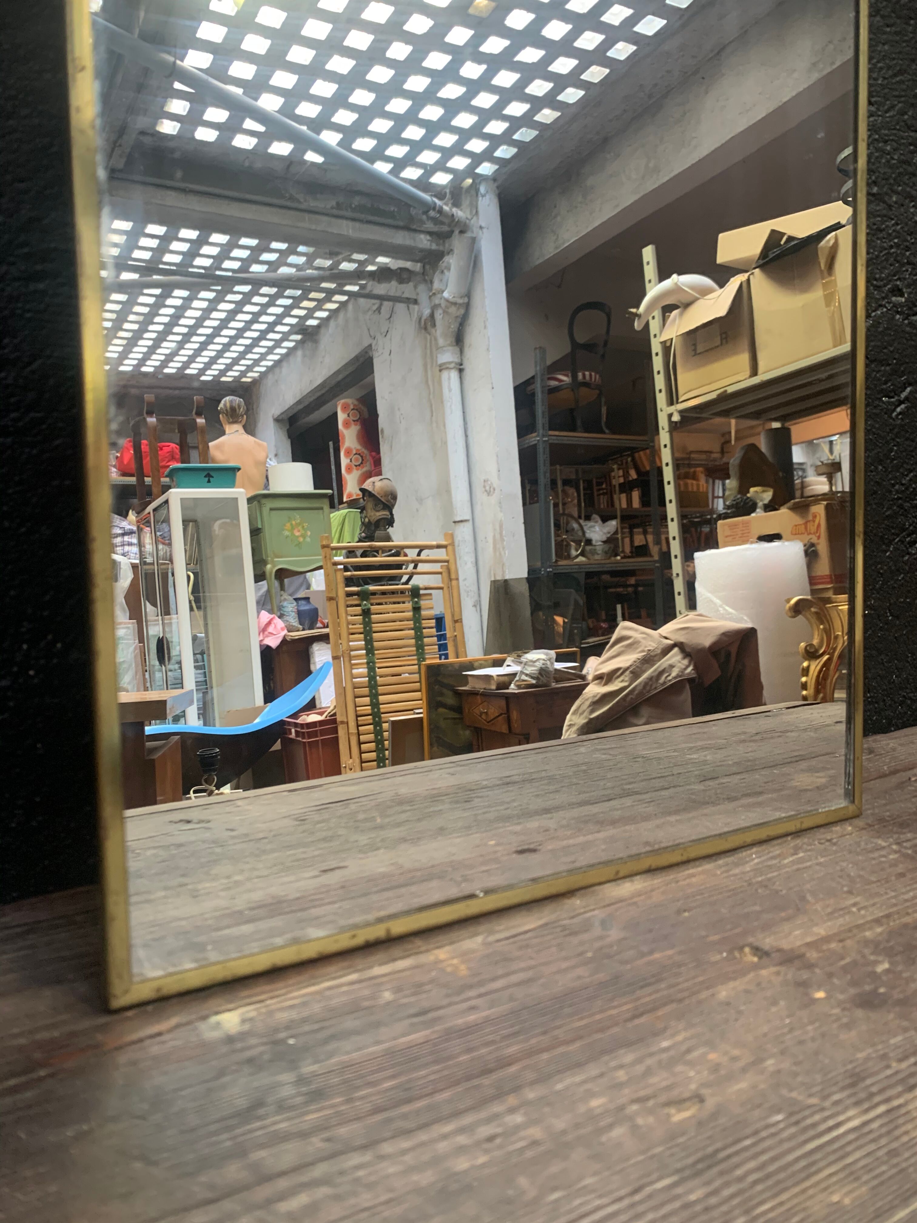 Mirror of two, narrow glass in gold metal 1950