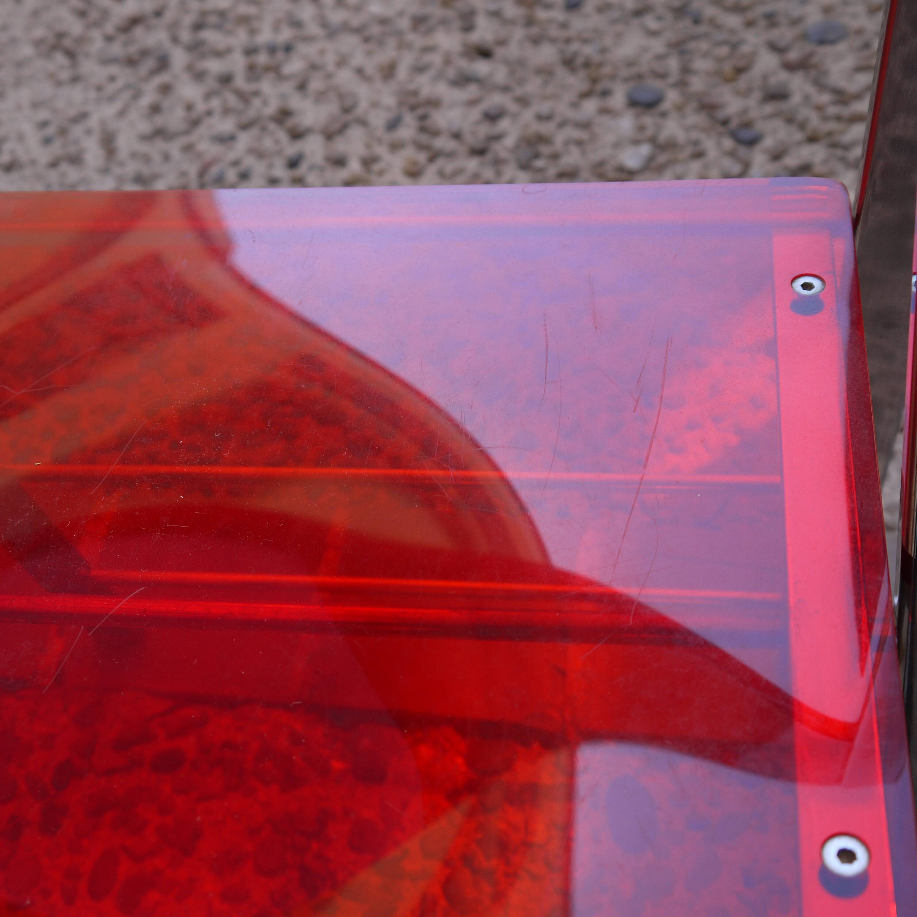 Red Plexiglas folding chair