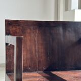 Small low armchair in varnished brown wood