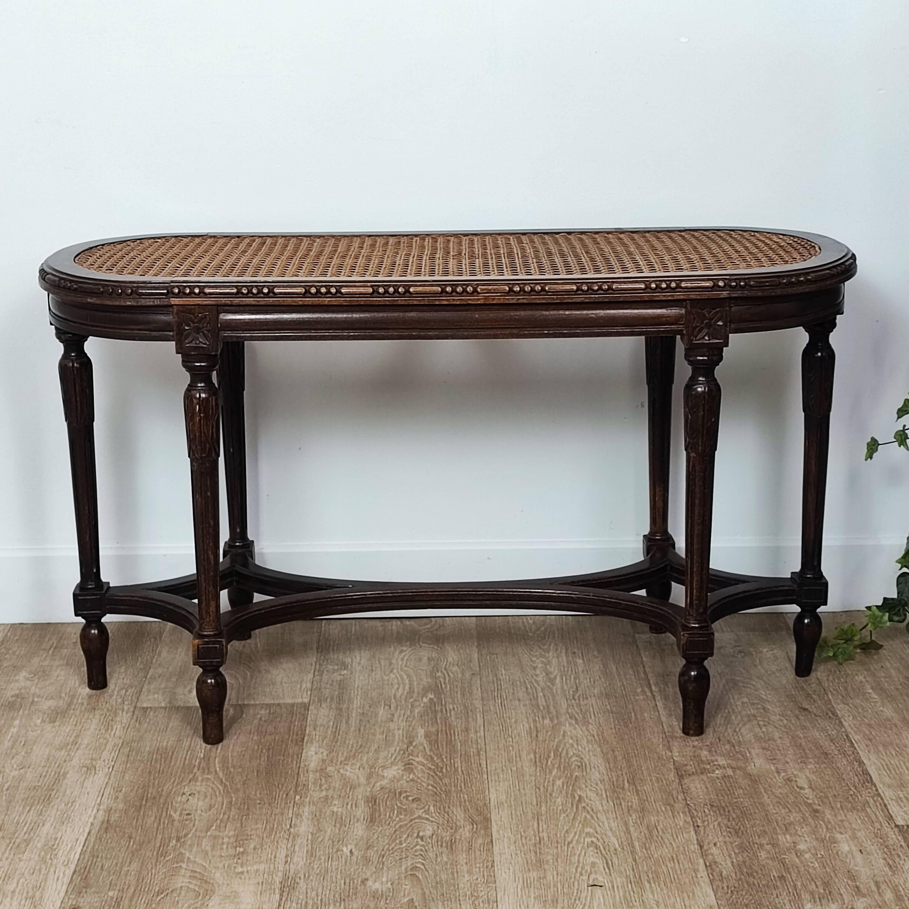 Caned piano bench