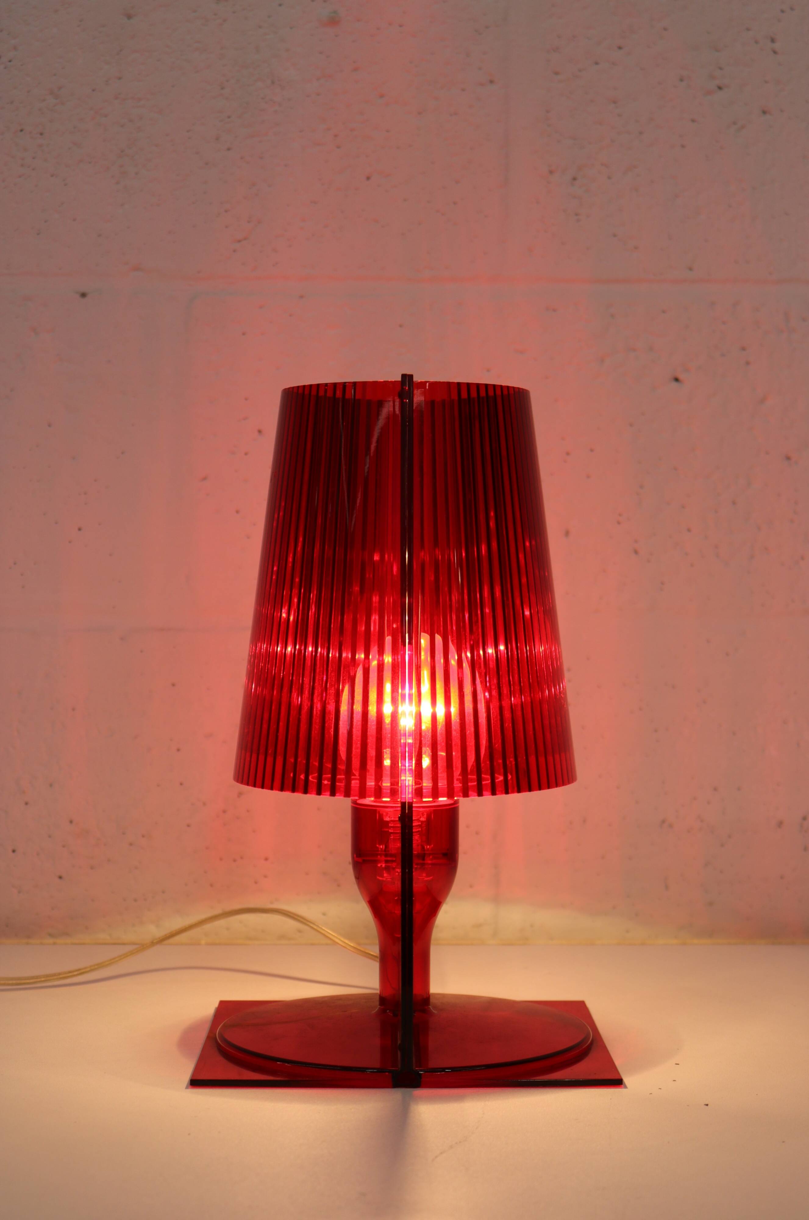 Red plastic Kartell table lamp - model Take - design by Ferruccio Laviani