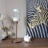 Table lamp with gold metal base and cylindrical textured glass shade