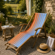 Vintage deck chair with orange and blue striped fabric, original patina.