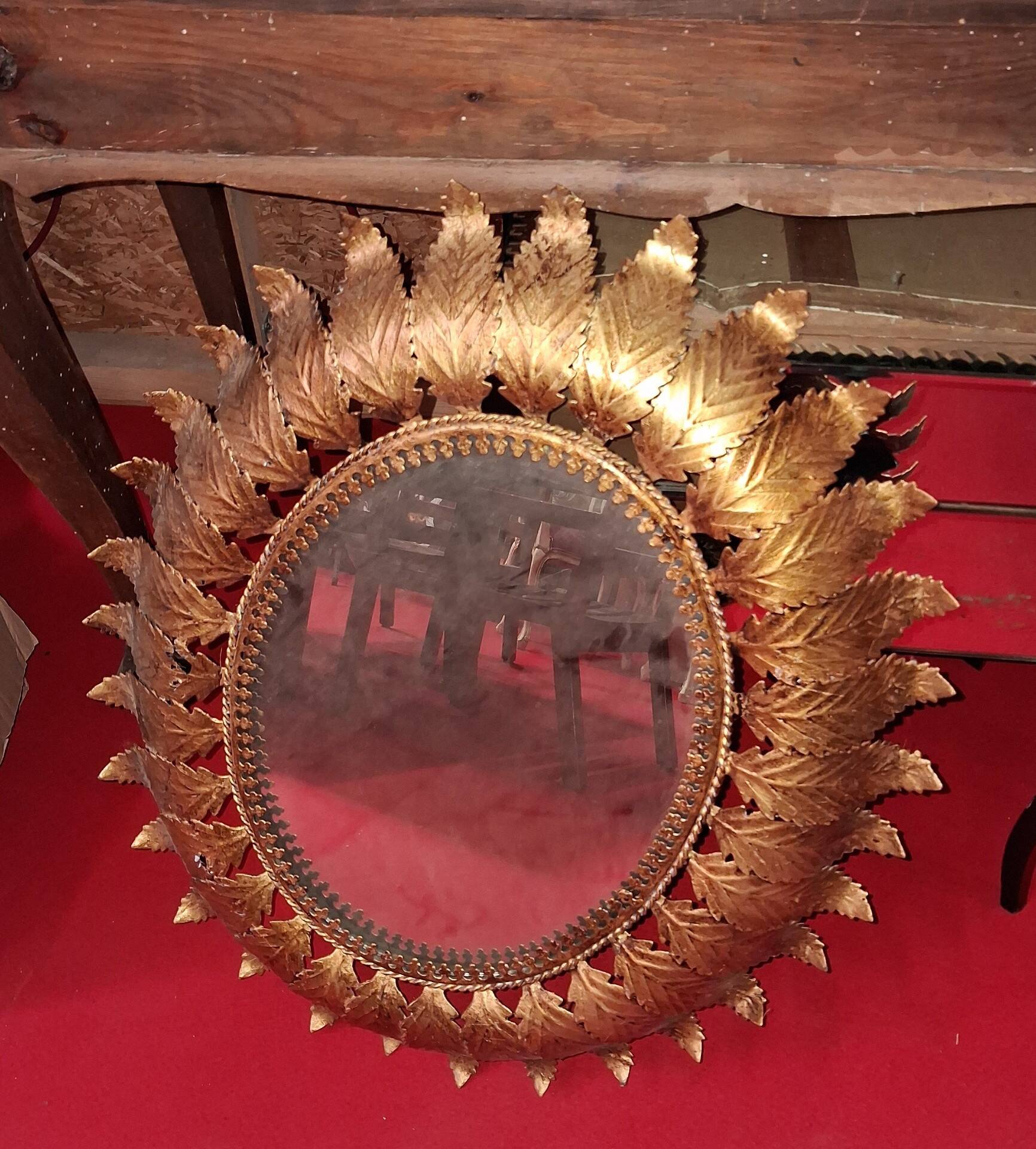Golden metal sun mirror with leaf decoration