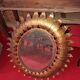 Golden metal sun mirror with leaf decoration